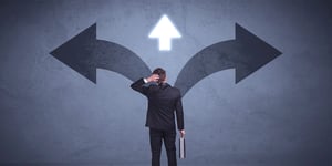 Man standing confused at crossroad Arrow pointing left, down the middle and to the right