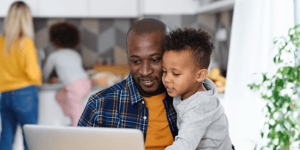 Father and son working on computer