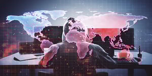 hacker in hoodie using computer digital world map