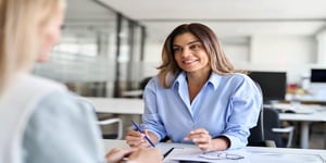 Businesswoman smiling at desk