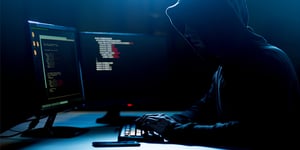 Cybercriminal hacking into computer data