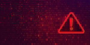 Red code on black background with red triangle warning sign
