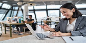 Sales woman smiling at computer talking