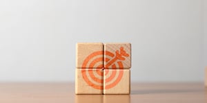 Blocks stacked together puzzle forming target with arrow