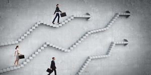 Business men and women climbing stone stairs 