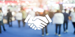 Vector handshake layered over blurred crowd of people