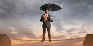 Man in Suit on Tightrope with Umbrella