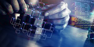 Hands building blocks with code in background all with a transparent blue hue overtop