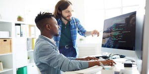 Two men looking at computer at work