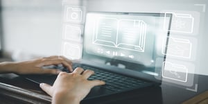 Hands typing on laptop