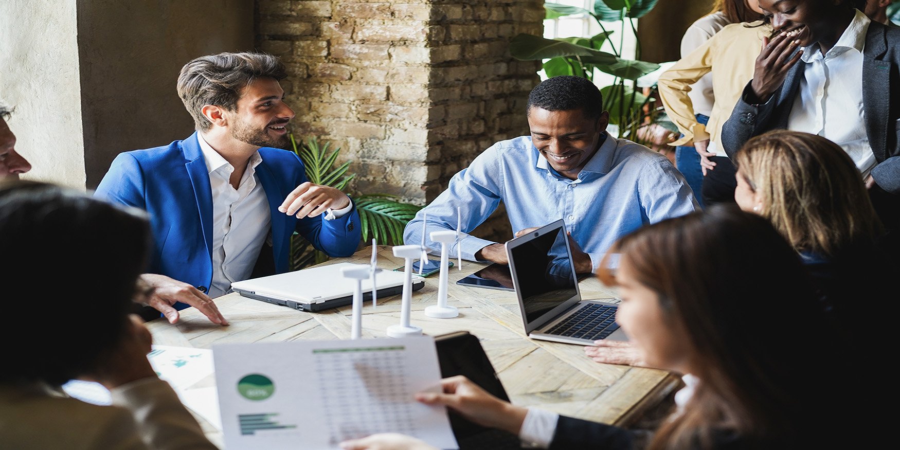 Diverse group of people working in tech in meeting
