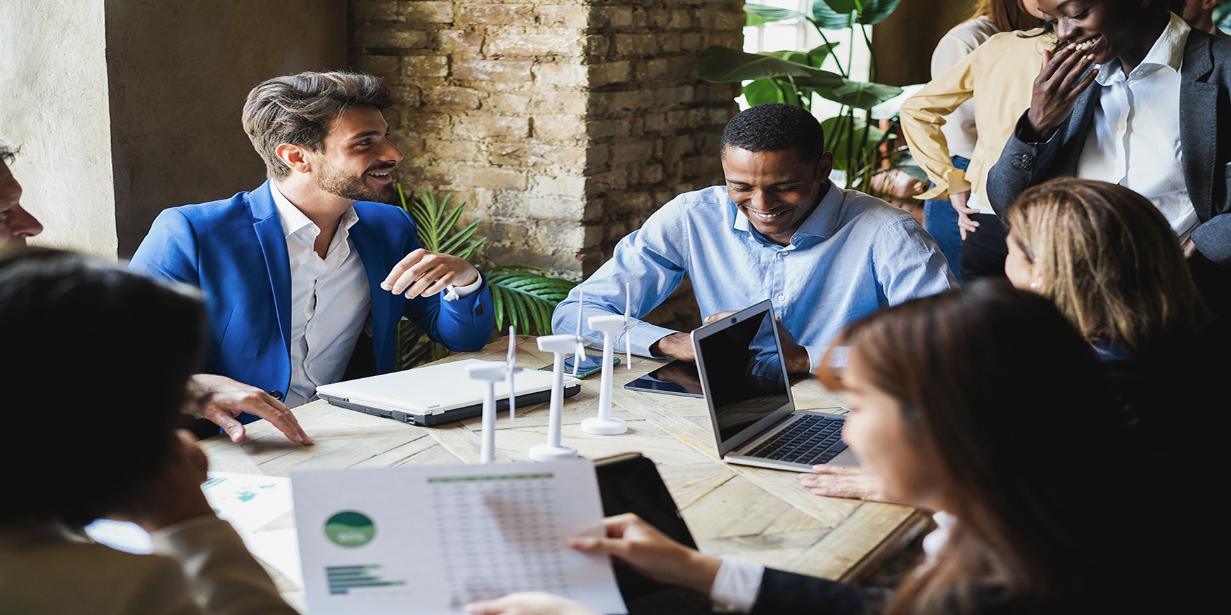 Diverse group of people working in tech in meeting