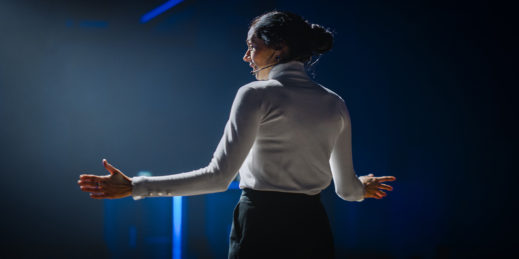 female motivational speaker on stage talking about technology