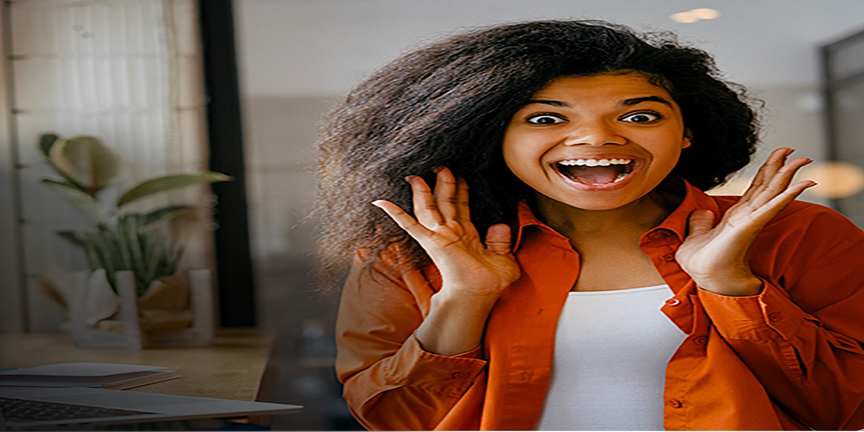 Woman in orange shirt excited and smiling