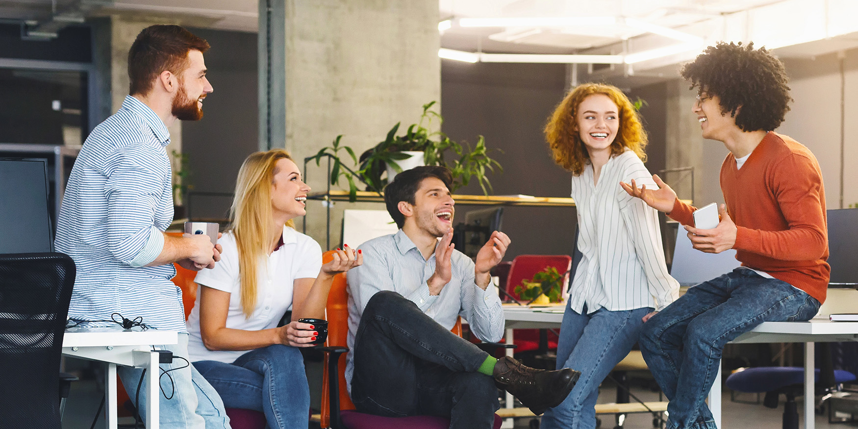 Friends at work chatting and smiling