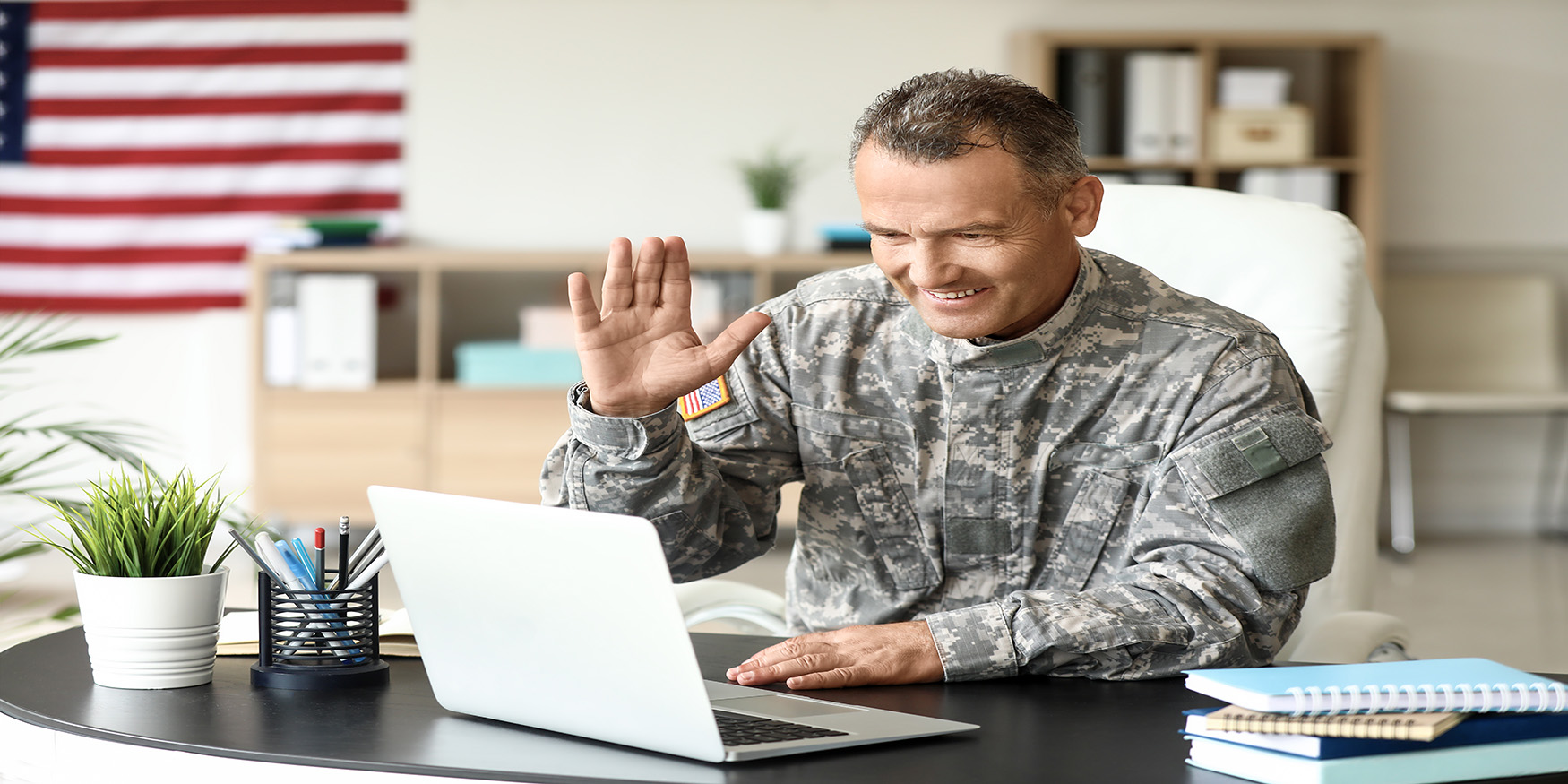 male soldier using laptop for a job interview