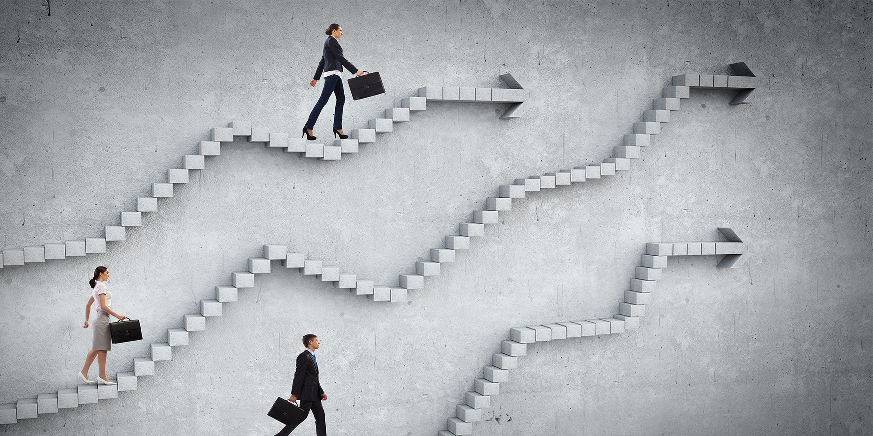 Business men and women climbing stone stairs 