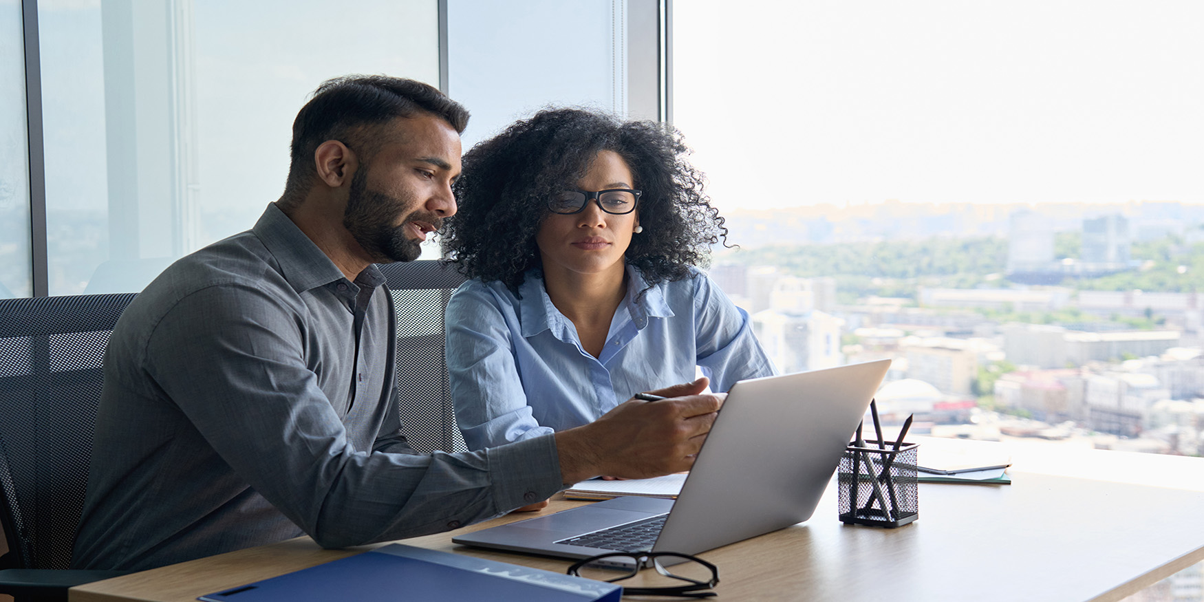 Client working with business partner looking at laptop