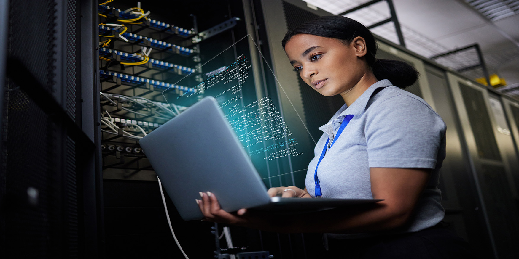Woman in cybersecurity on laptop network data center